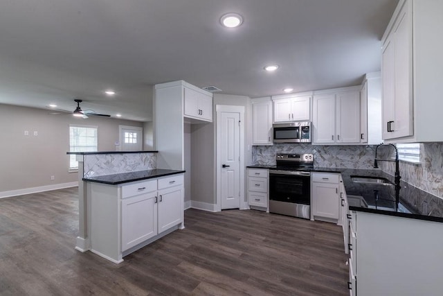 kitchen with white cabinets, appliances with stainless steel finishes, ceiling fan, and sink