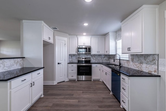 kitchen featuring sink, dark wood-type flooring, tasteful backsplash, white cabinets, and appliances with stainless steel finishes