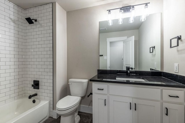 full bathroom featuring vanity, toilet, and tiled shower / bath