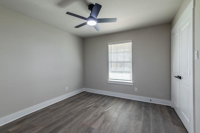 unfurnished room with dark hardwood / wood-style floors and ceiling fan