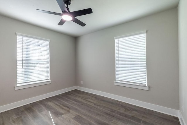 empty room featuring dark hardwood / wood-style flooring and ceiling fan