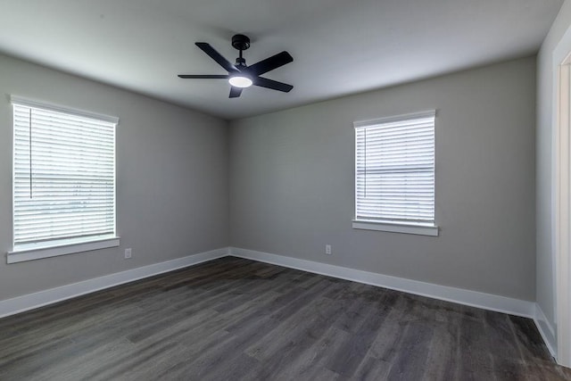 empty room with dark hardwood / wood-style flooring and ceiling fan