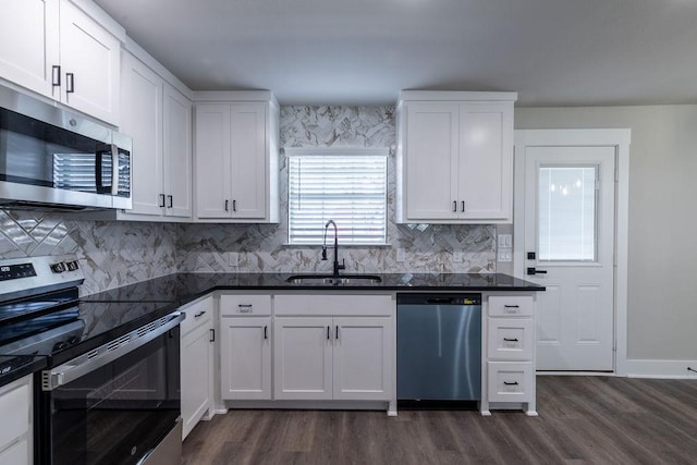 kitchen with white cabinets, dark hardwood / wood-style flooring, stainless steel appliances, and sink