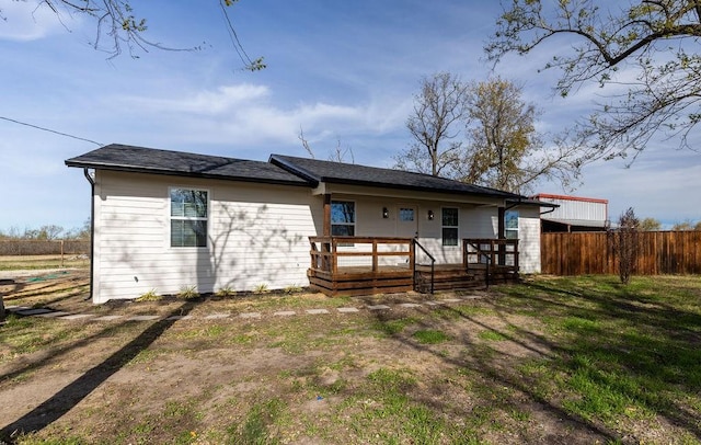 rear view of house featuring a yard