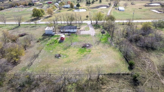 birds eye view of property with a rural view