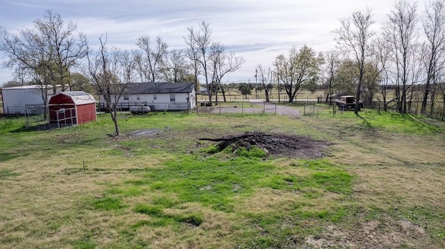 view of yard with a rural view and an outdoor structure