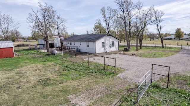 view of yard with a rural view and an outdoor structure