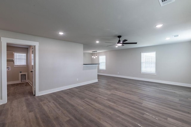 unfurnished living room with dark hardwood / wood-style floors and ceiling fan