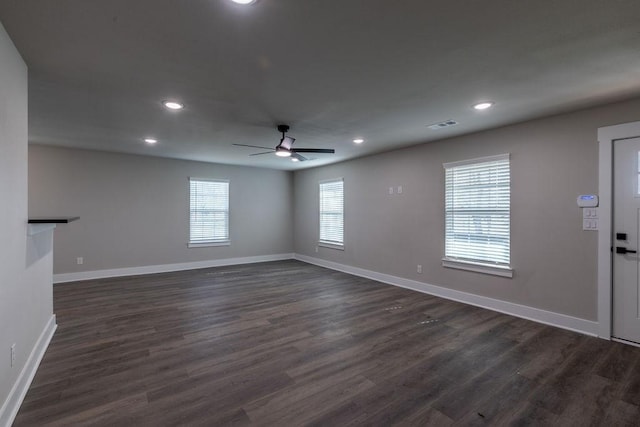 spare room featuring ceiling fan and dark hardwood / wood-style flooring