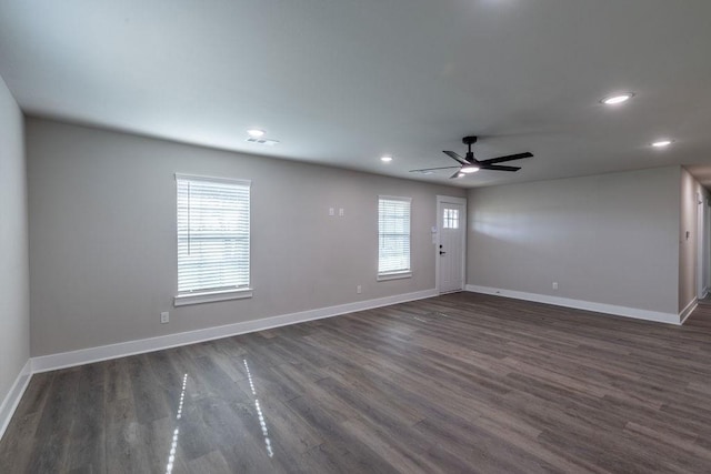 empty room featuring ceiling fan and dark wood-type flooring