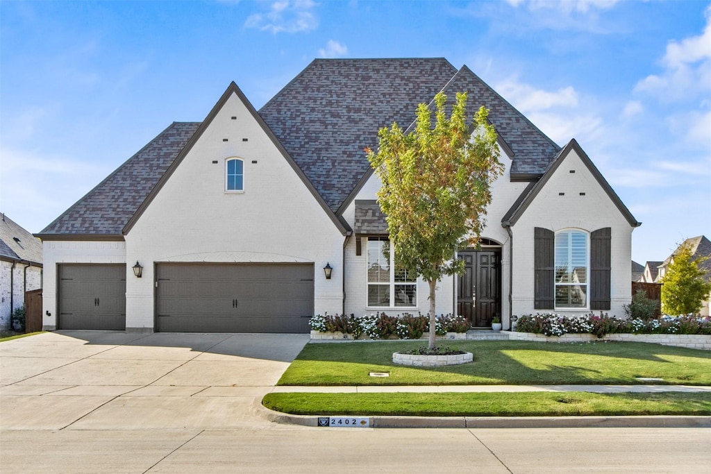 french provincial home featuring a front yard