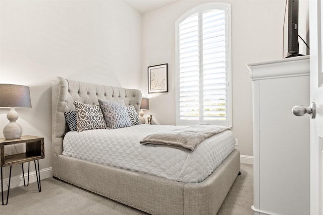 bedroom featuring light carpet