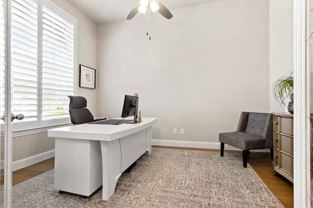 office space with dark wood-type flooring and ceiling fan