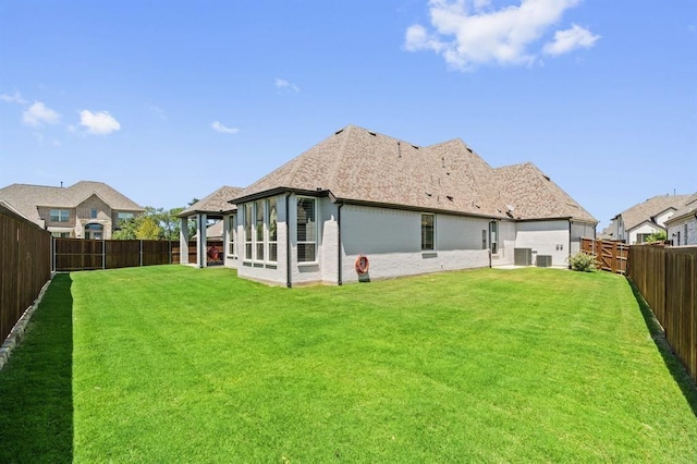 back of property featuring cooling unit and a lawn