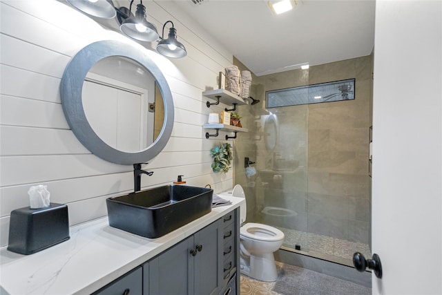 bathroom with vanity, toilet, and a shower with shower door