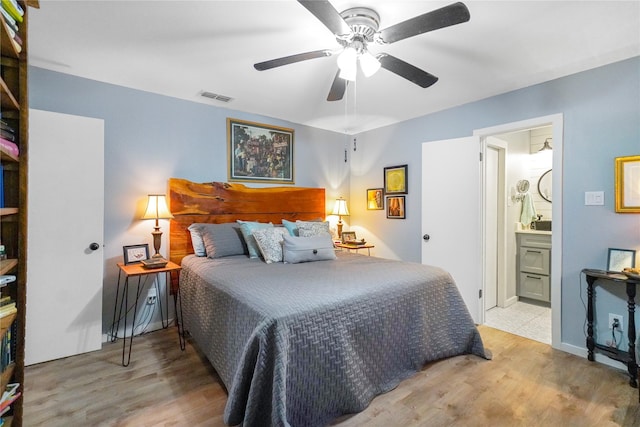 bedroom with ceiling fan, light hardwood / wood-style floors, and connected bathroom