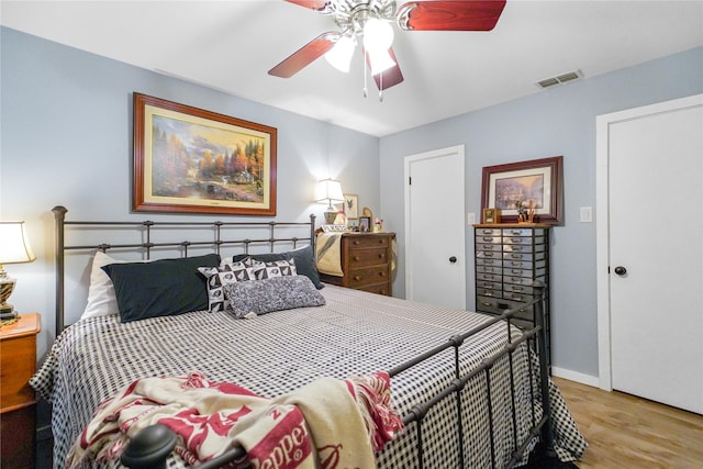 bedroom with ceiling fan and light hardwood / wood-style floors