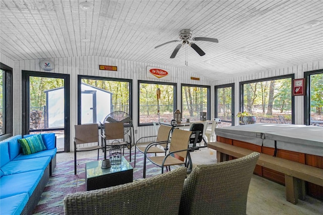 sunroom with vaulted ceiling, plenty of natural light, ceiling fan, and wood ceiling