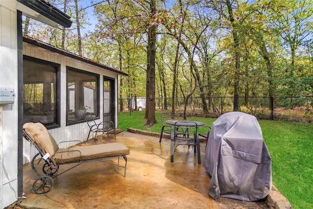 view of patio / terrace featuring a grill and a sunroom