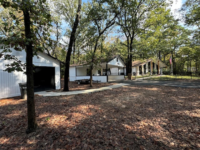 view of front of house with a garage and an outdoor structure