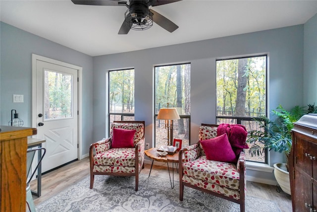 sitting room with ceiling fan and light hardwood / wood-style flooring