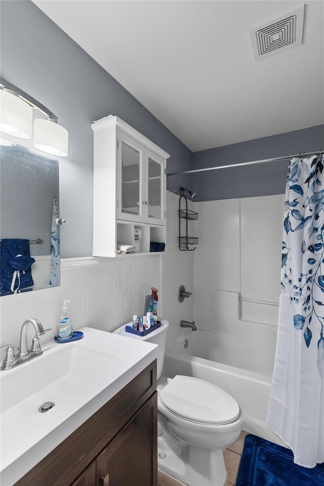 full bathroom featuring tile patterned floors, vanity, shower / bathtub combination with curtain, and toilet