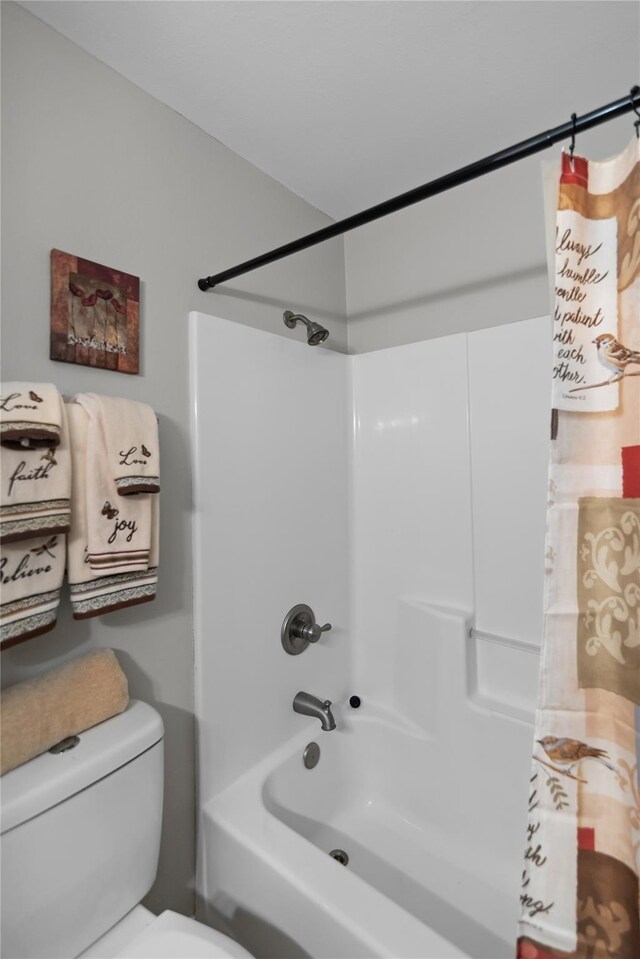 bathroom with toilet and shower / tub combo with curtain