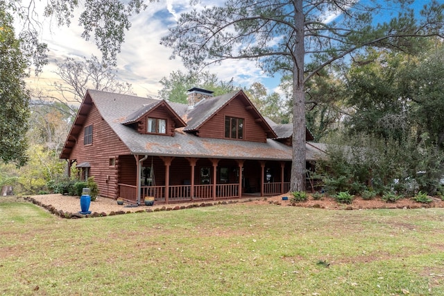 view of front of home with covered porch and a lawn