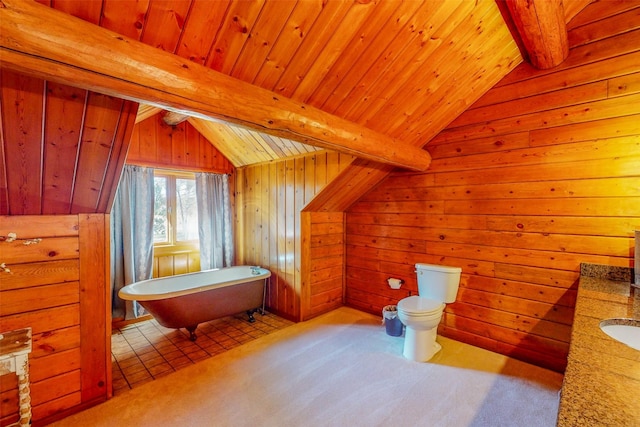 bathroom featuring lofted ceiling with beams, wood walls, toilet, and a tub