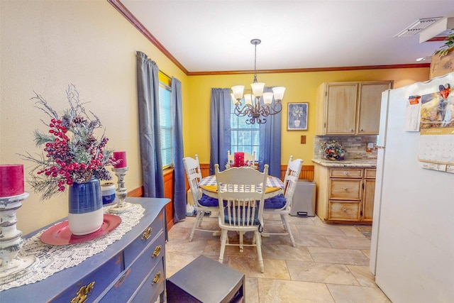 dining area featuring ornamental molding and a notable chandelier