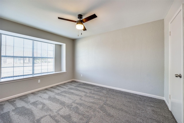 carpeted empty room featuring ceiling fan