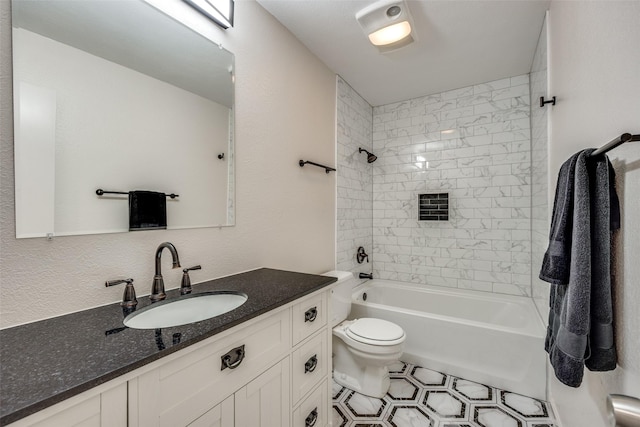 full bathroom featuring toilet, vanity, and tiled shower / bath