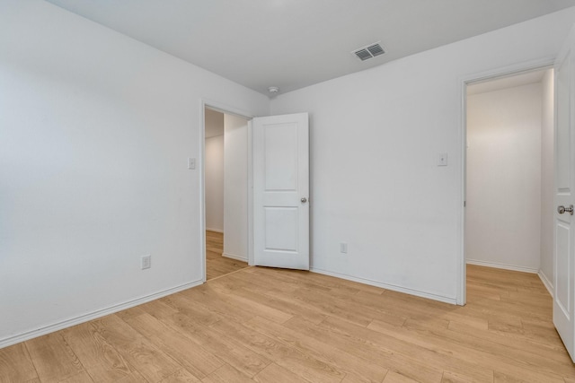 empty room with light hardwood / wood-style floors