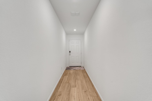 corridor with light hardwood / wood-style flooring