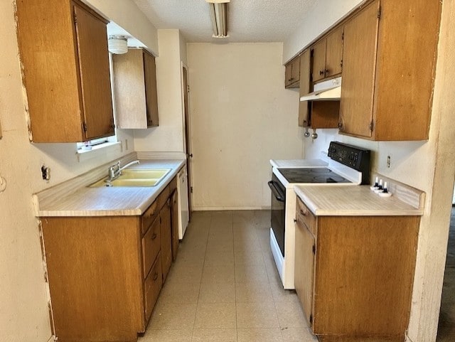 kitchen featuring a textured ceiling, white appliances, and sink