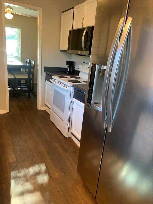 kitchen with ceiling fan, white cabinetry, stainless steel appliances, and dark wood-type flooring