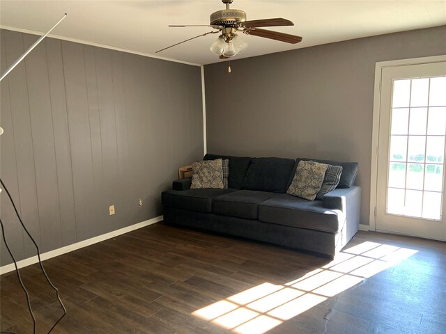 unfurnished living room featuring ceiling fan and dark wood-type flooring