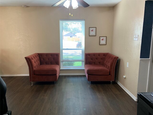 living area featuring dark hardwood / wood-style floors, ceiling fan, and a wealth of natural light