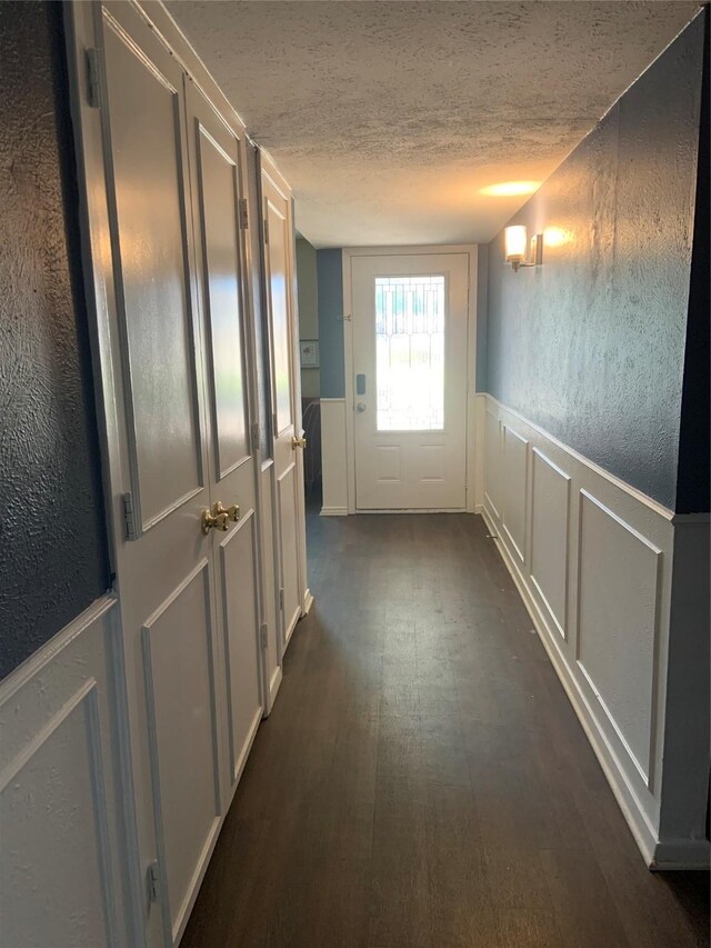 hall featuring a textured ceiling