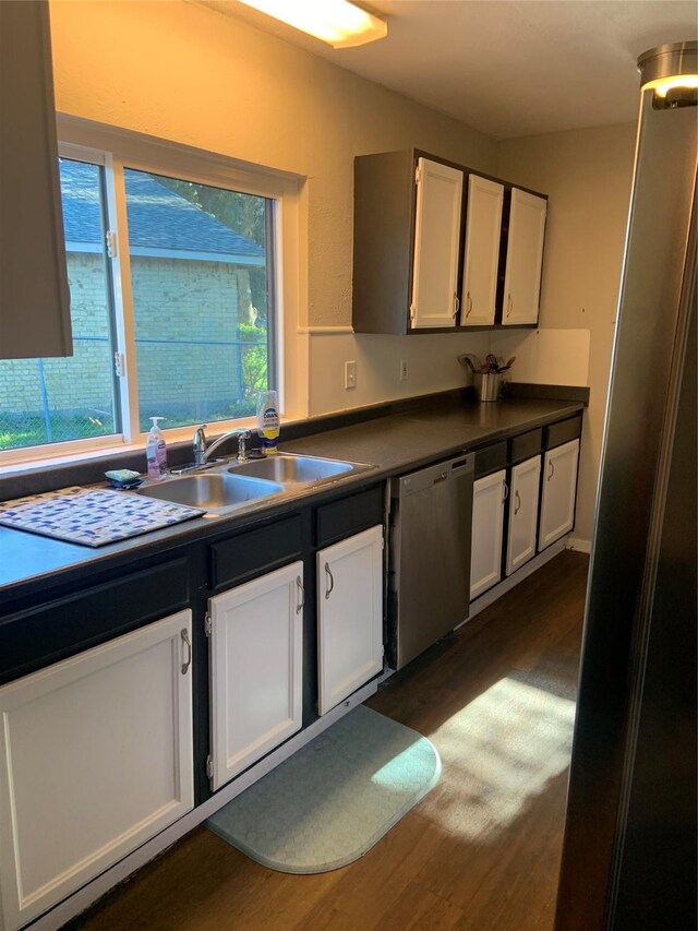 kitchen with white cabinetry, dishwasher, sink, dark wood-type flooring, and plenty of natural light