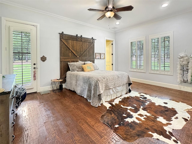 bedroom with access to exterior, ceiling fan, a barn door, dark hardwood / wood-style floors, and ornamental molding