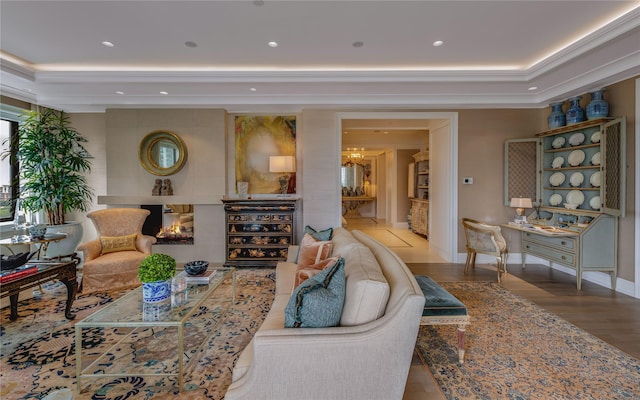 living room with a tiled fireplace and light hardwood / wood-style flooring