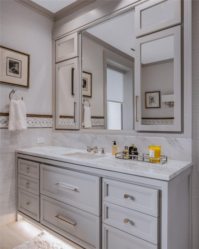 bathroom with vanity and tile walls