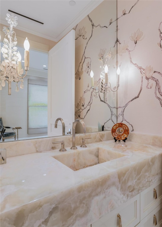 bathroom featuring ornamental molding and vanity