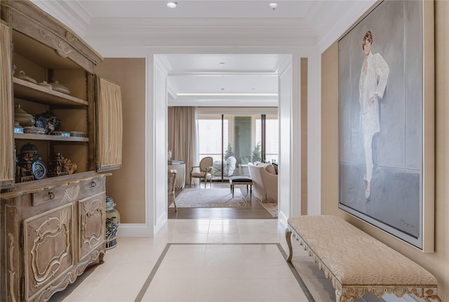 hall featuring crown molding and light tile patterned floors