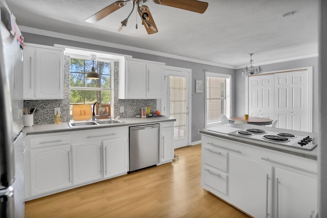 kitchen with sink, ornamental molding, appliances with stainless steel finishes, light hardwood / wood-style floors, and white cabinets