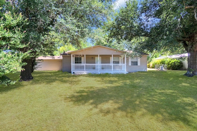 rear view of property with a lawn and a porch