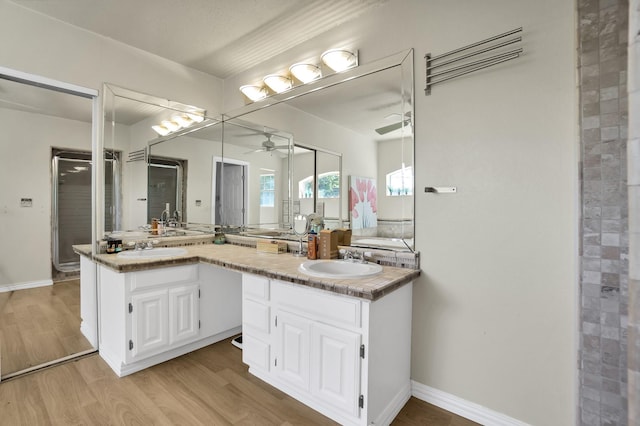 bathroom with vanity, hardwood / wood-style floors, and ceiling fan