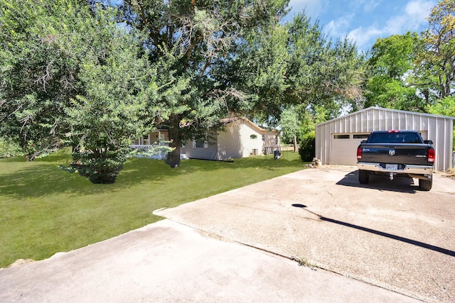 exterior space featuring an outbuilding, a garage, and a lawn