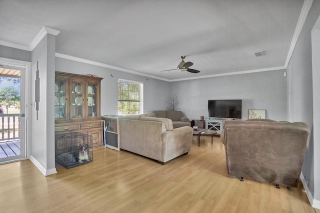 living room featuring ceiling fan, ornamental molding, and light hardwood / wood-style floors